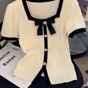 Elegant Cream Blouse with Black Trim and Bow